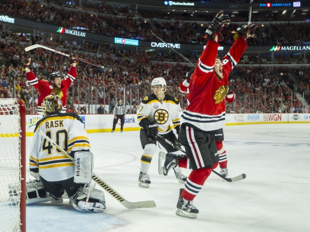 The thrill of victory; the agony of defeat: Andrew Shaw of the Chicago Blackhawks (right) celebrates after the game-winning goal goes in. Boston Bruins goaltender Tuukka Rask  looks back toward the puck that's now in his net